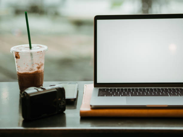 istock Empty screen laptop with camera and ice coffee in the cafe. 1055430672