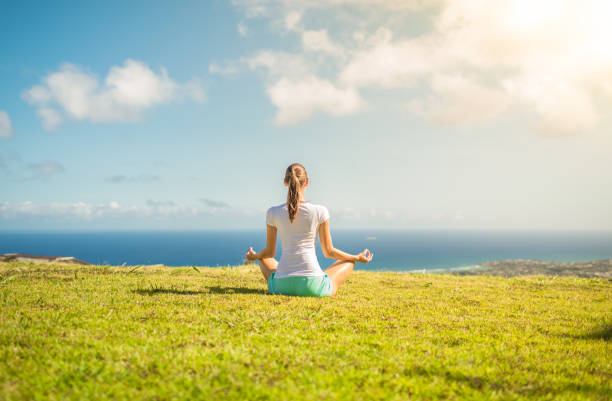 Woman mediating in a beautiful nature setting.
