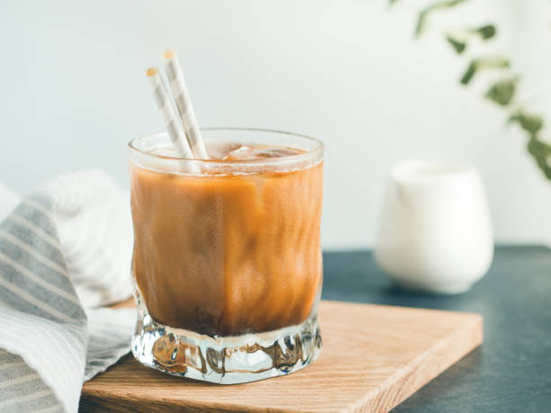 istock Refreshing iced latte in a glass with straws in a modern kitchen. 1055437542