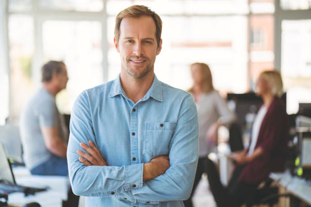 istock Confident businessman standing with arms crossed 1055437726
