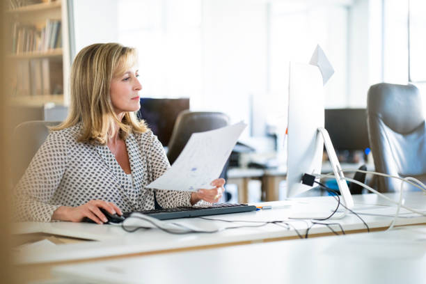 istock Confident businesswoman using computer at desk 1055437852