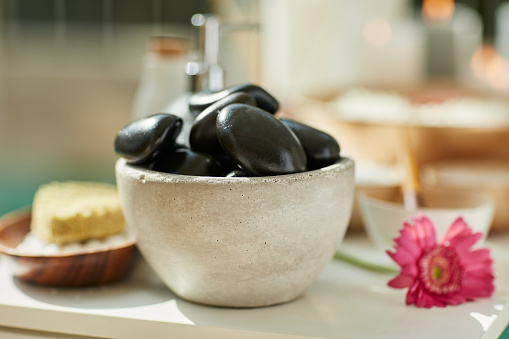 Cropped shot of a bowl with hot stones in a spa
