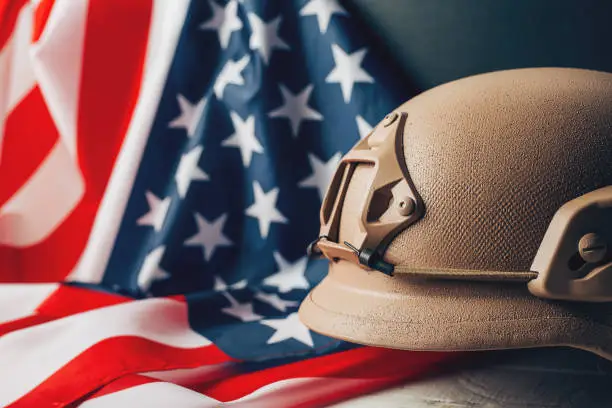 Photo of Military helmets and American flag on background