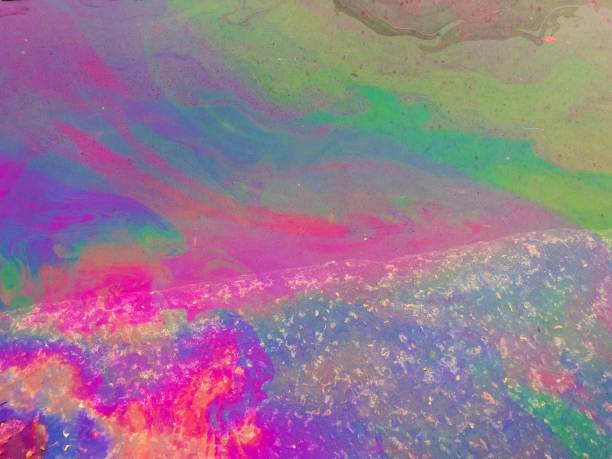 istock Oil Spill Rainbow Water Background 1055442898