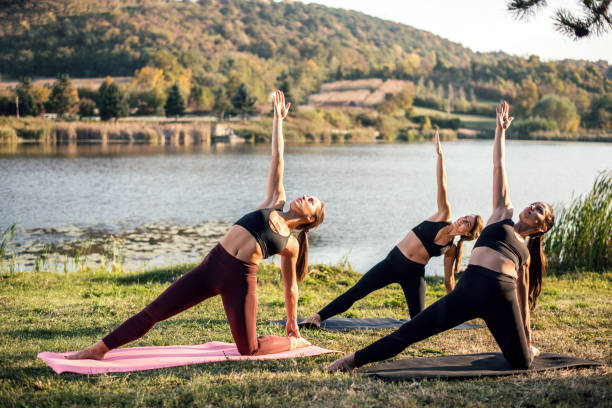 istock Women doing yoga on the lake 1055445364