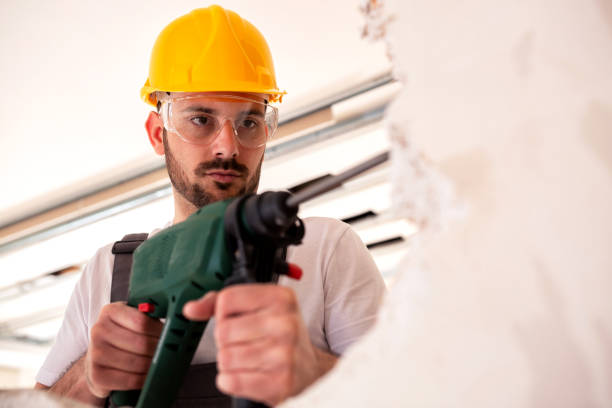 istock Drilling holes in an old worn out wall 1055445772