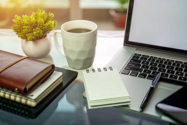 istock Laptop, coffee and books on desk. 1055446018