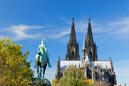 Cologne Cathedral and Kaiser Wilhelm I. sculpture in brilliant autumn light, Cologne, Germany
