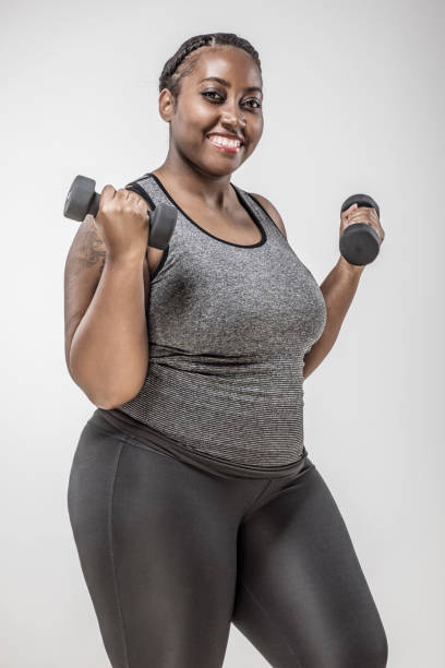 istock Overweight young woman working out 1055446204