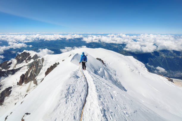 Trekking to the top of Mont Blanc mountain in French Alps mountaineer going to Mont Blanc along the ridge chamonix photos stock pictures, royalty-free photos & images