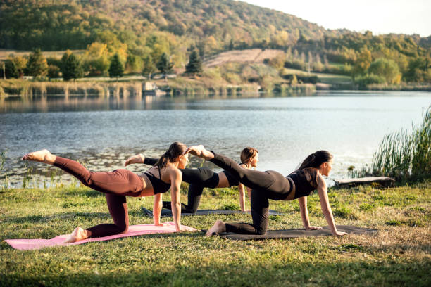 Women doing yoga on the lake