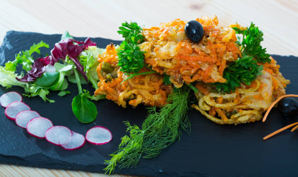 istock Deep-fried vegetables with greens, radish, black olives 1055448430