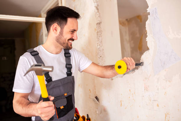 istock With pointed chisel in one hand and a hammer in the other 1055448918