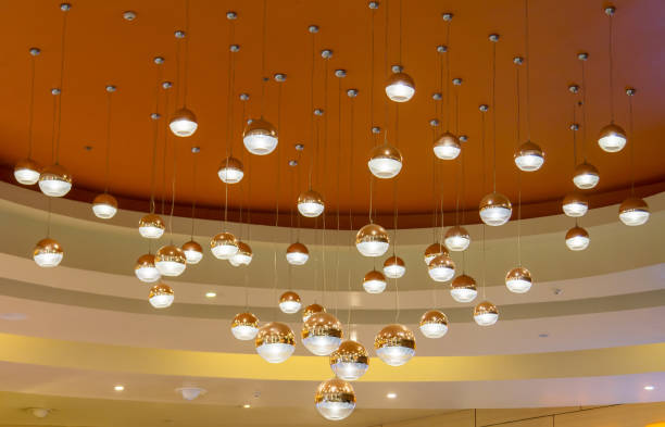 istock Modern streamlined mirror oval copper chandelier is a branched ornamental light fixture designed to be mounted on ceilings or walls. 1055448982