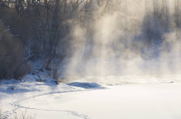 istock Fog over the river with beautiful sunlight in winter 1055451410