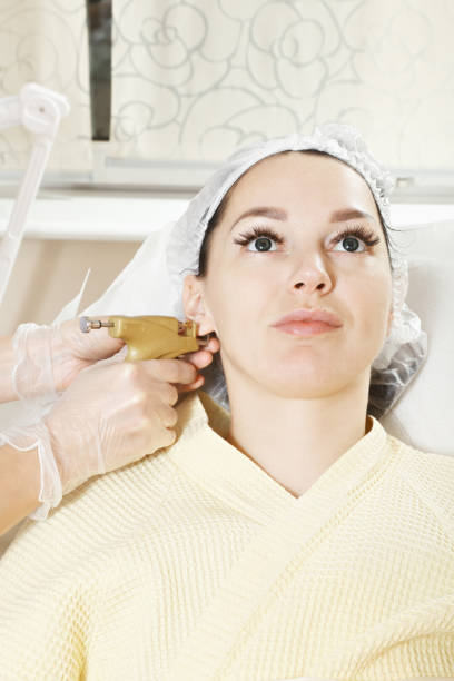 Getting ear pierced stock photo