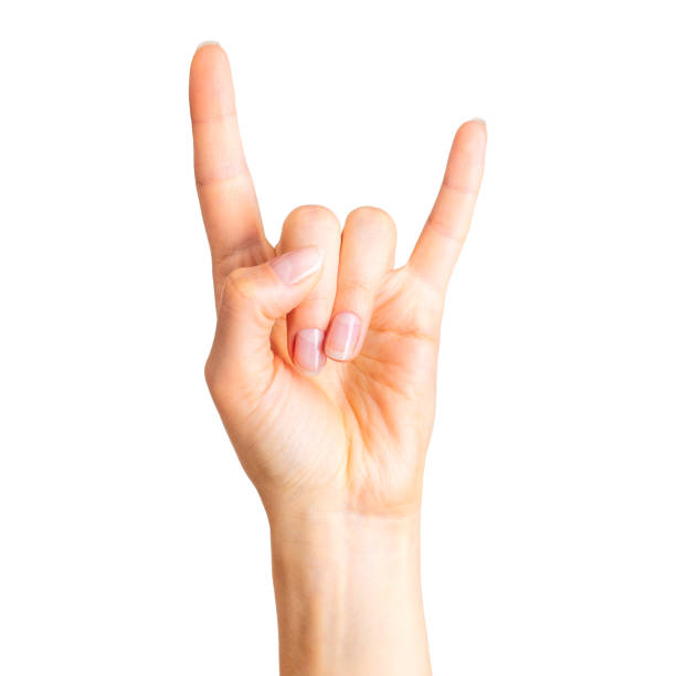 mano femminile che mostra il segno rock n roll o dà il gesto delle corna del diavolo - rock and roll foto e immagini stock