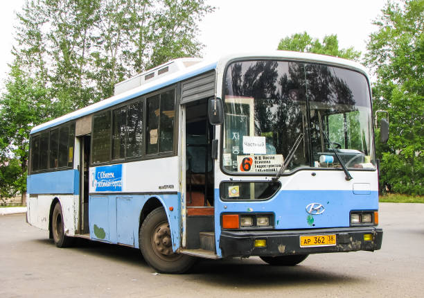 Side view of a white bus on the road.