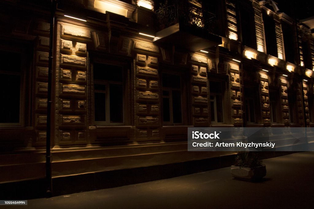 Urban building facade details illuminated Urban building facade details illuminated on autumn night Architectural Cornice Stock Photo