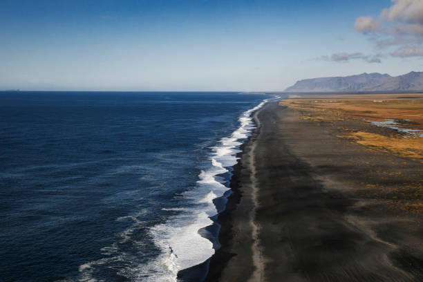 istock Black volcanic beach view from Dyrholaey Lighthouse in Iceland 1055455124