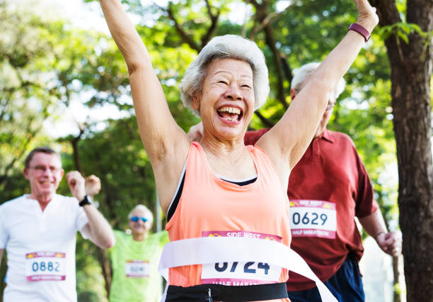 istock Happy senior running through the finish line 1055456408