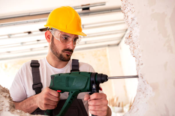istock Drilling holes in an old worn out wall 1055456790