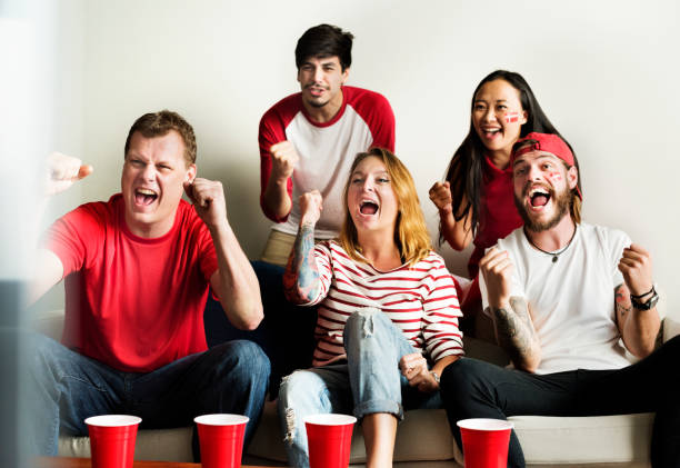 istock Friends cheering world cup with painted flag 1055457132