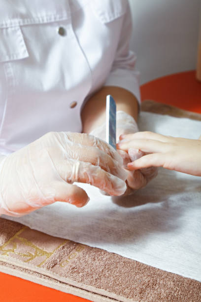 istock Polishing child nails 1055457158