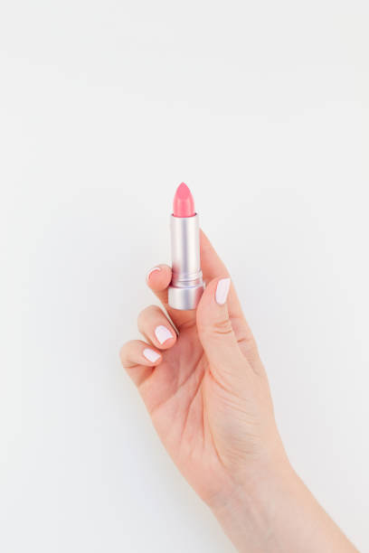 istock Woman hand with pink lipstick 1055457808