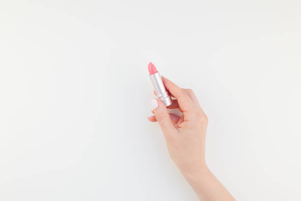 istock Woman hand with pink lipstick 1055457832