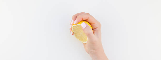 istock Woman hand with lemon 1055457890