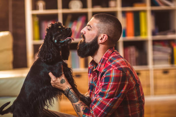 istock Handsome man with cute dog at home 1055460056
