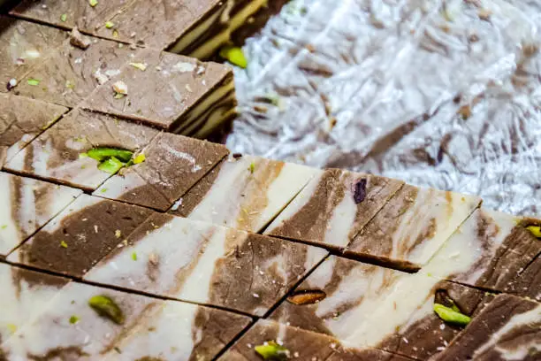 Diamond-cut, chocolate nougat. Eastern sweets. Curd cake Indian sweets