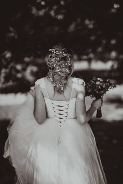 istock Black white photo happy young bride on forest background 1055461100