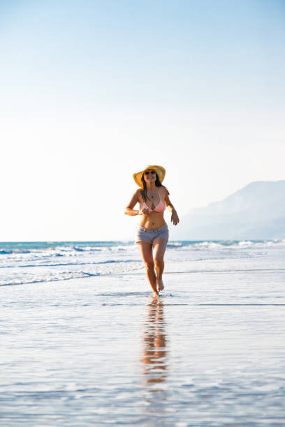 istock Woman is runnning on the sea 1055464568