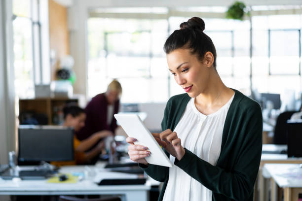 istock Confident young businesswoman using digital tablet 1055465452