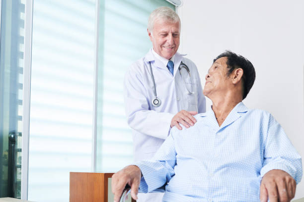 istock Smiling doctor encouraging senior patient 1055465584