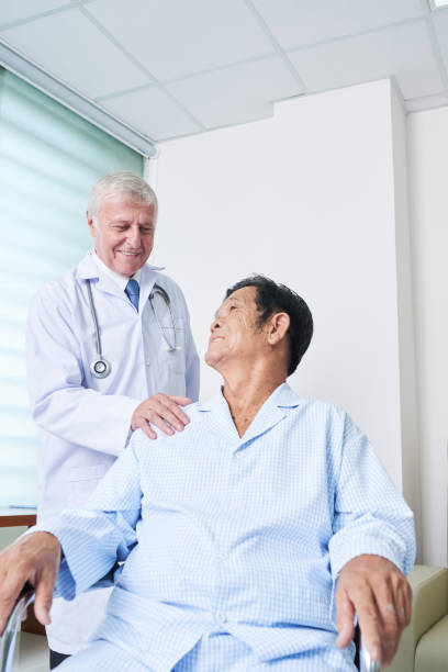 istock Smiling patient and doctor looking at each other 1055465586