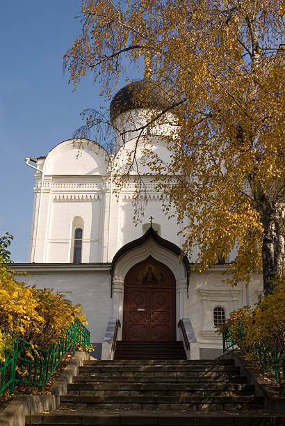 Ancient cathedral in fall color park stock photo