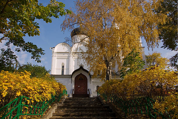 Ancient cathedral in fall color park stock photo