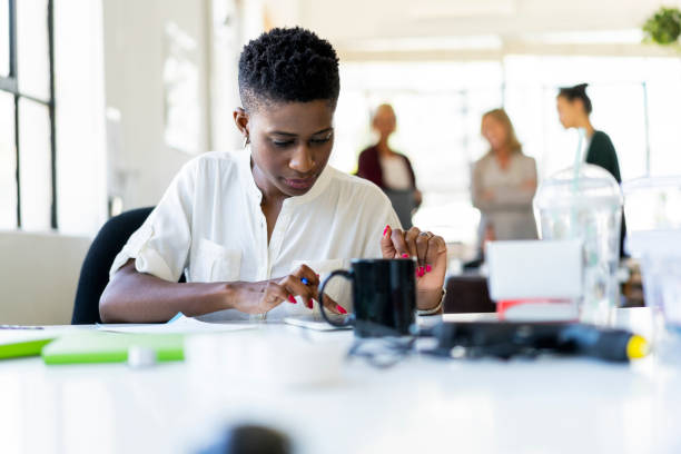 istock Confident businesswoman using tablet at desk 1055466970