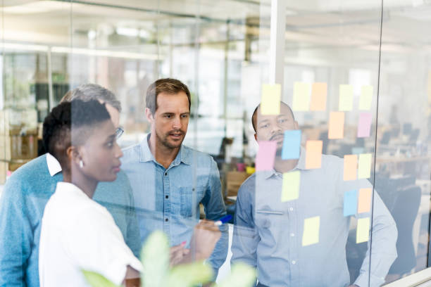istock Business colleagues discussing over adhesive notes 1055467184