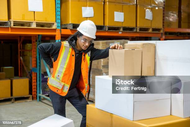 A Man Experiencing Back Pain At Work Stock Photo - Download Image Now - Ergonomics, Occupation, Picking Up