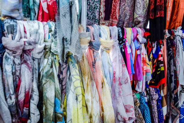 istock Indian fabrics hanging on the counter. Trade in fabrics from india. Fabric with patterns and patterns 1055467510