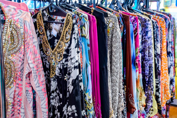 istock Indian fabrics hanging on the counter. Trade in fabrics from india. Fabric with patterns and patterns 1055467522