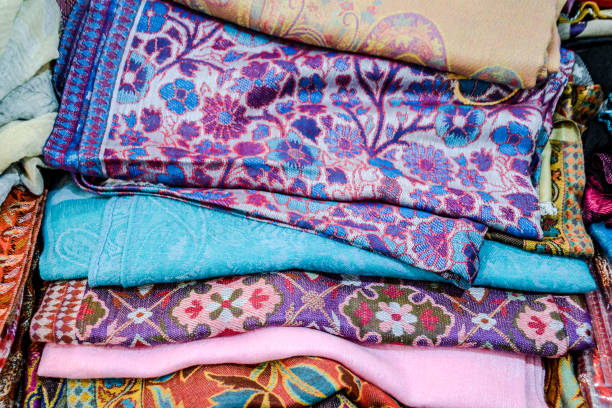 istock Indian fabrics folded on the counter. Trade in fabrics from india. Fabric with patterns and patterns 1055467524
