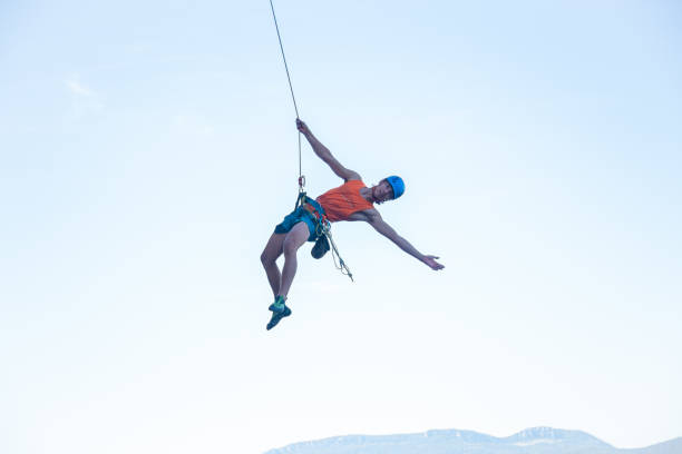 istock Flying climber on rope above ground 1055469232