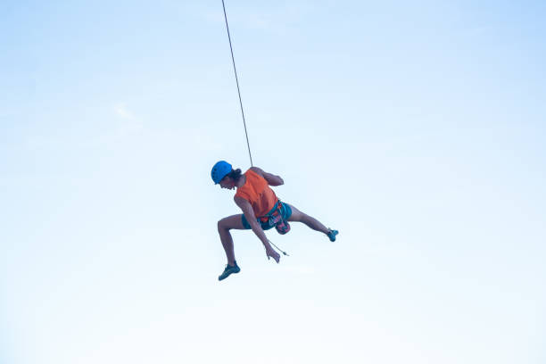 istock Flying climber on rope above ground 1055469236