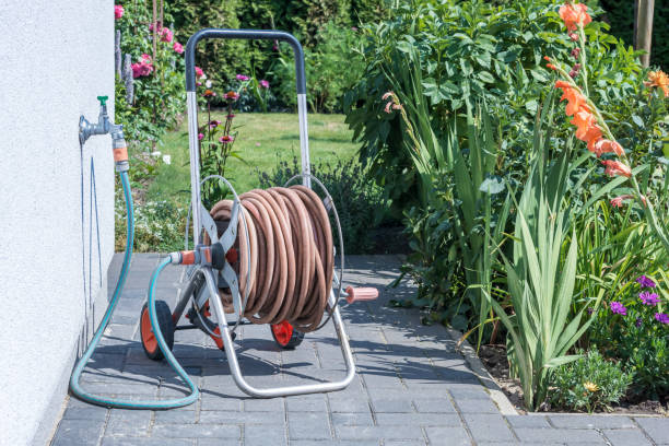 istock Coiled garden hose on a cold water pipe 1055469242