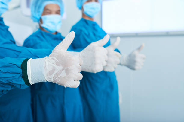 istock Crop surgical team gesturing thumb-up 1055470386